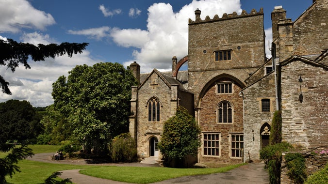 View of Buckland Abbey, Garden and Estate, Devon with blue skies and wispy clouds above